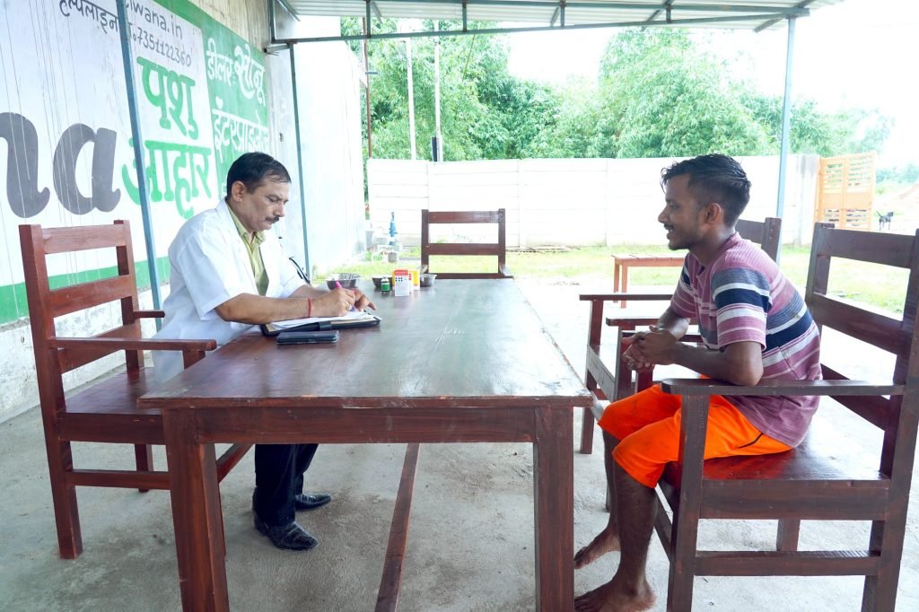 A veterinarian in consultation with a farmer